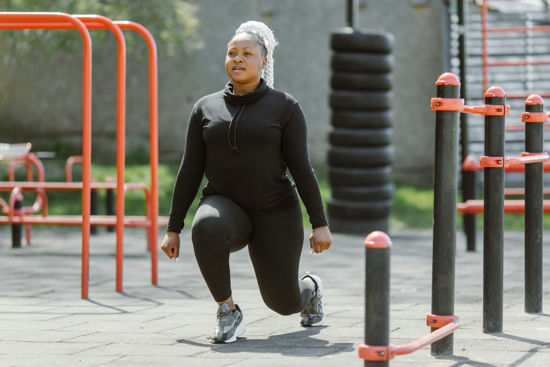 Woman performing lunges outdoors as part of a bone-strengthening exercise routine